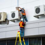 Workers Repairing Air Condition — Electric Services in Emerald, QLD